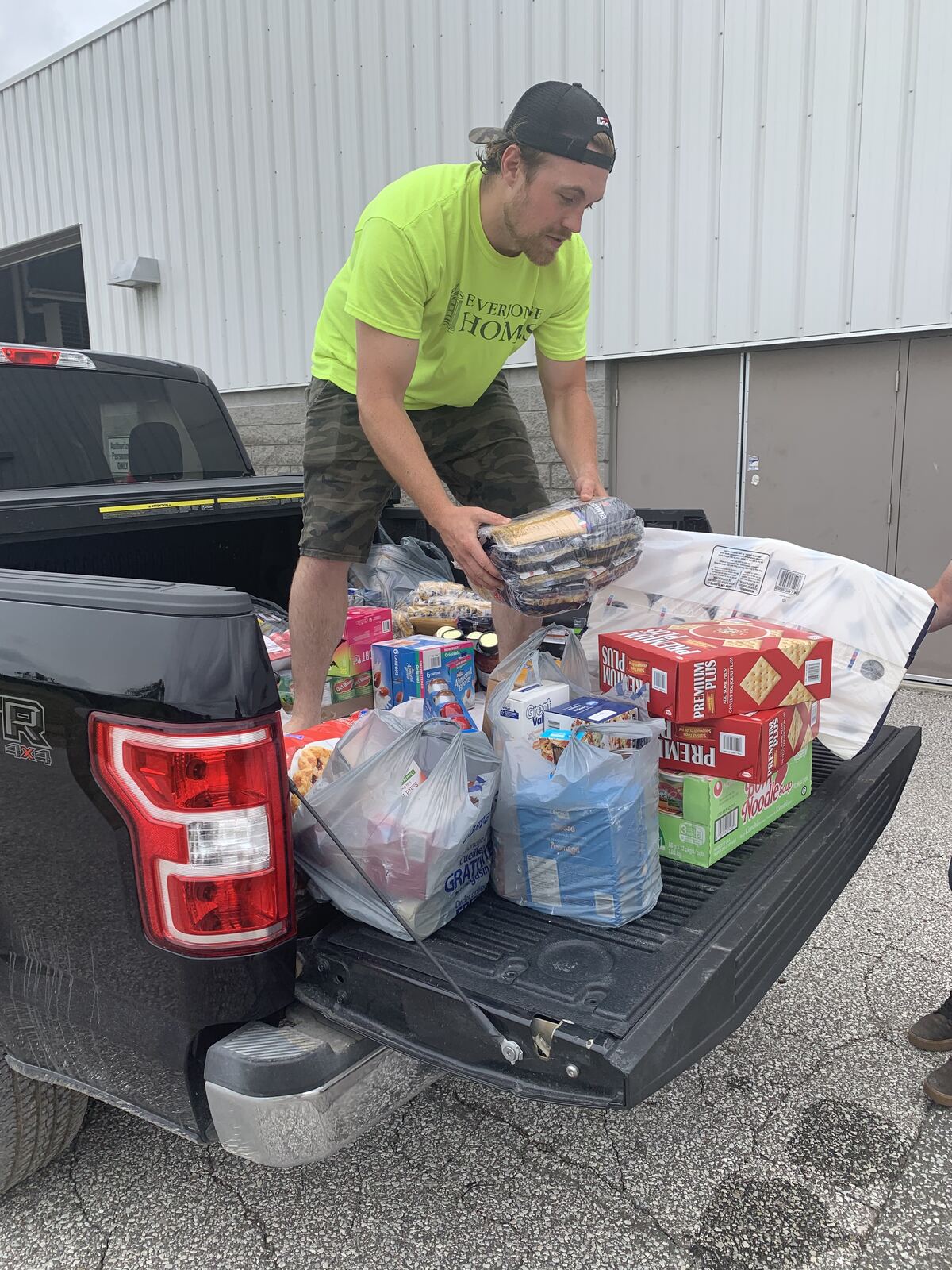 An EverJonge team member loading donated groceries into a truck