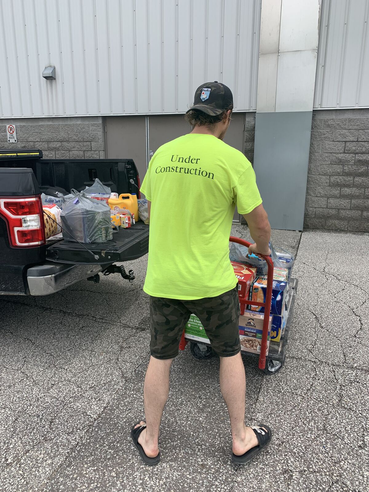 Wheeling a cart of donated supplies for delivery
