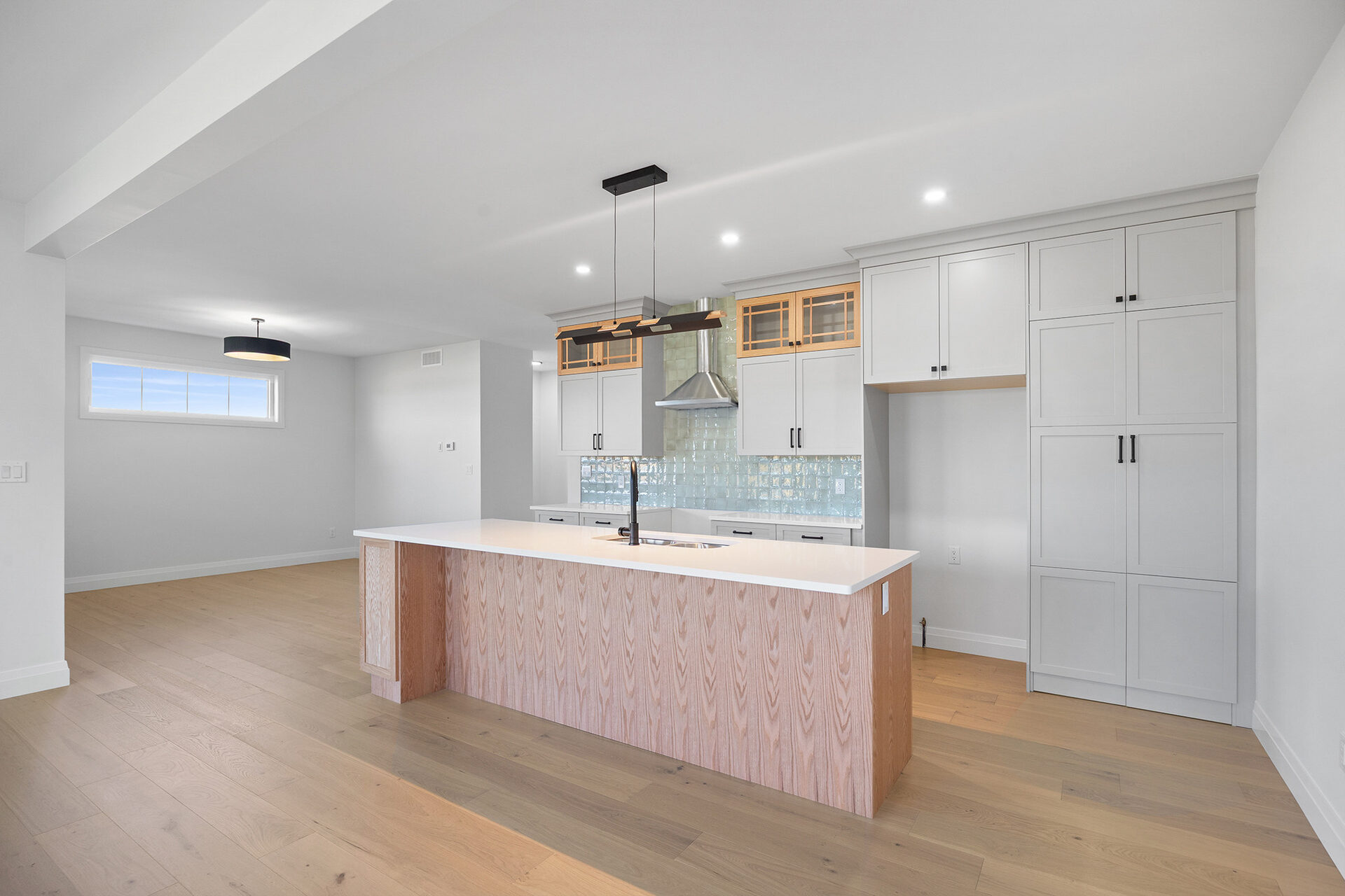 Kitchen cabinetry to the ceiling with a wood-panelled island