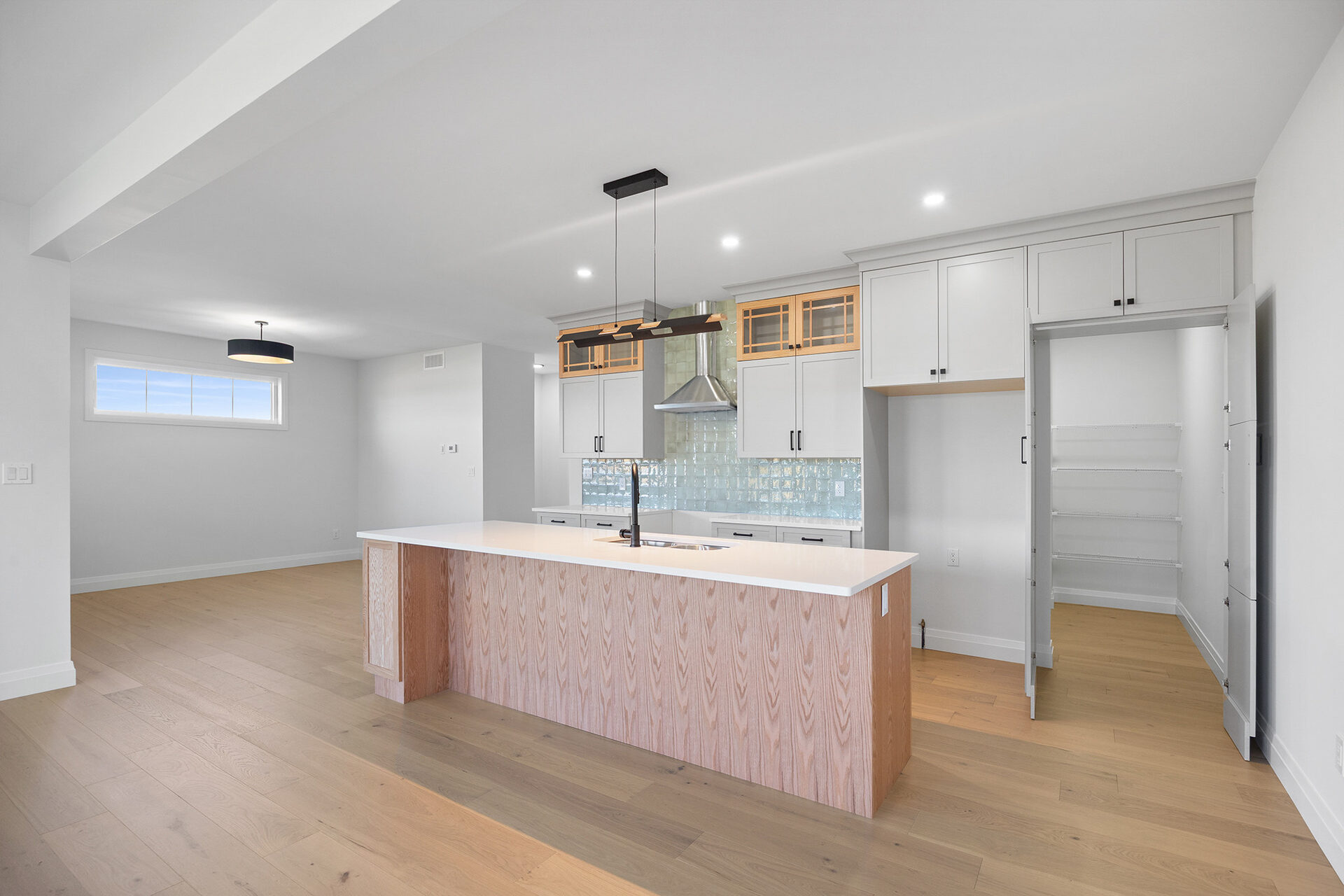 Kitchen and great room in an Erie Isle home, hardwood running through