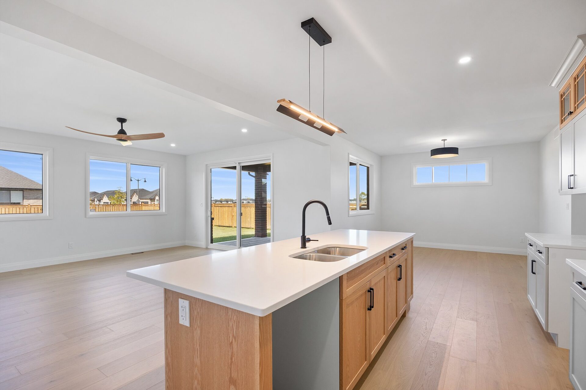 Quartz kitchen island in an Erie Isle home, open to the great room