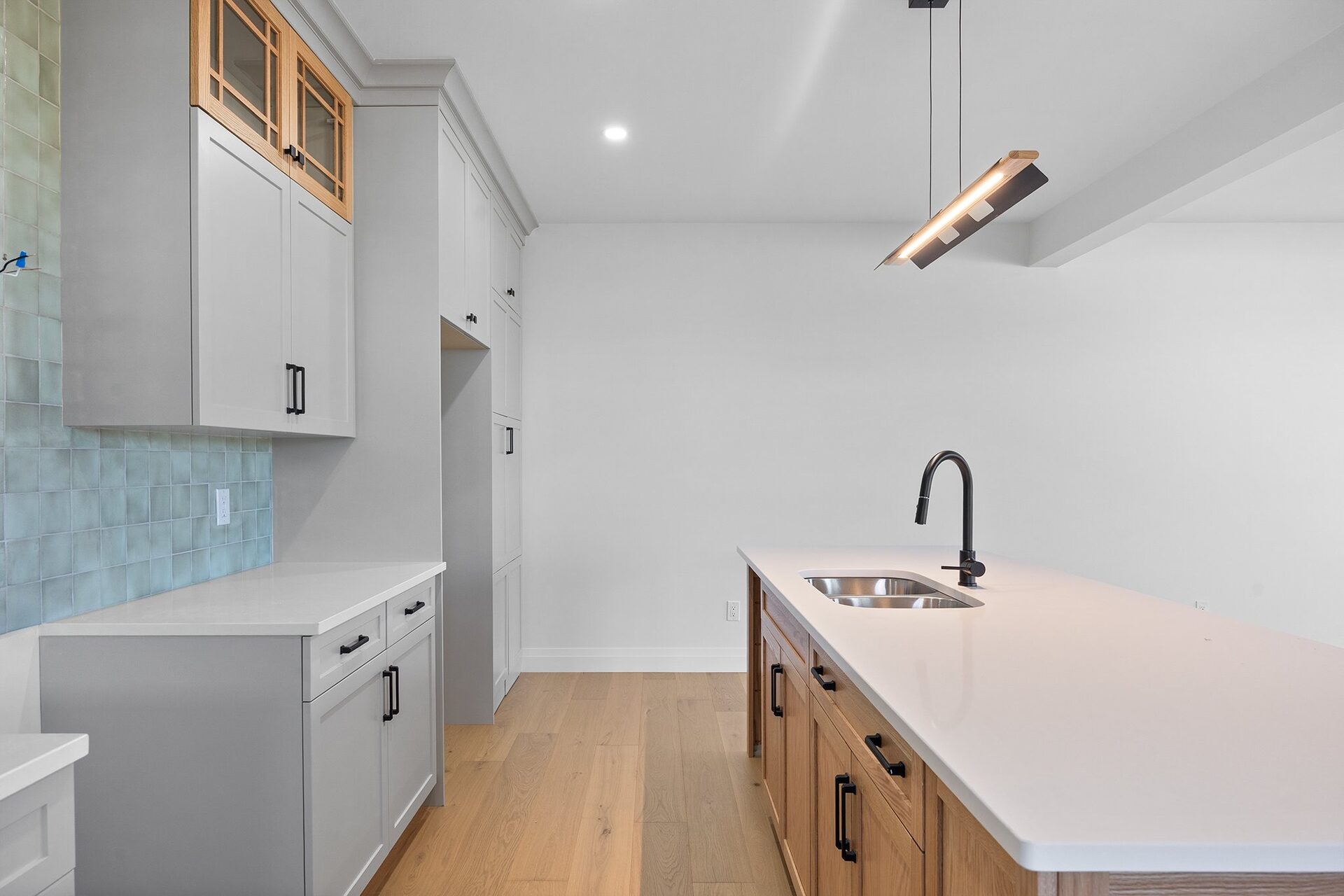 Kitchen sink and prep run, with the tiled backsplash behind