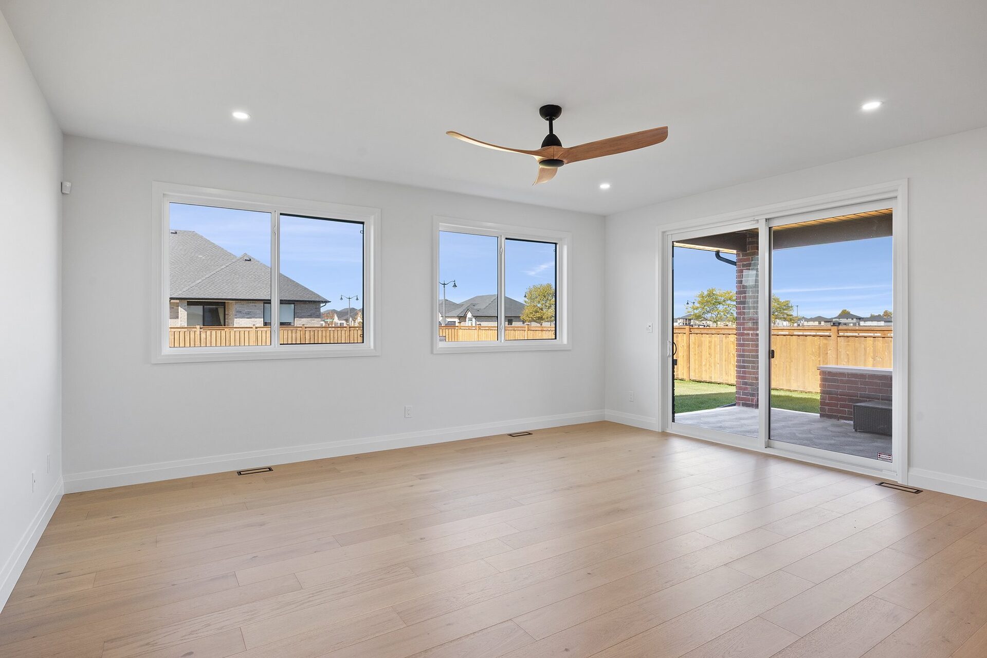 Living room in an Erie Isle home with sliding doors to the rear yard