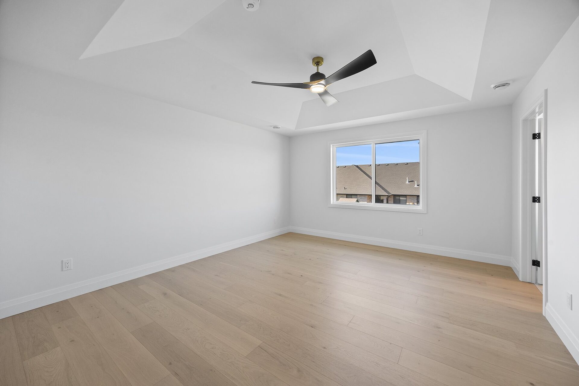 Primary bedroom in an Erie Isle home with a tray ceiling