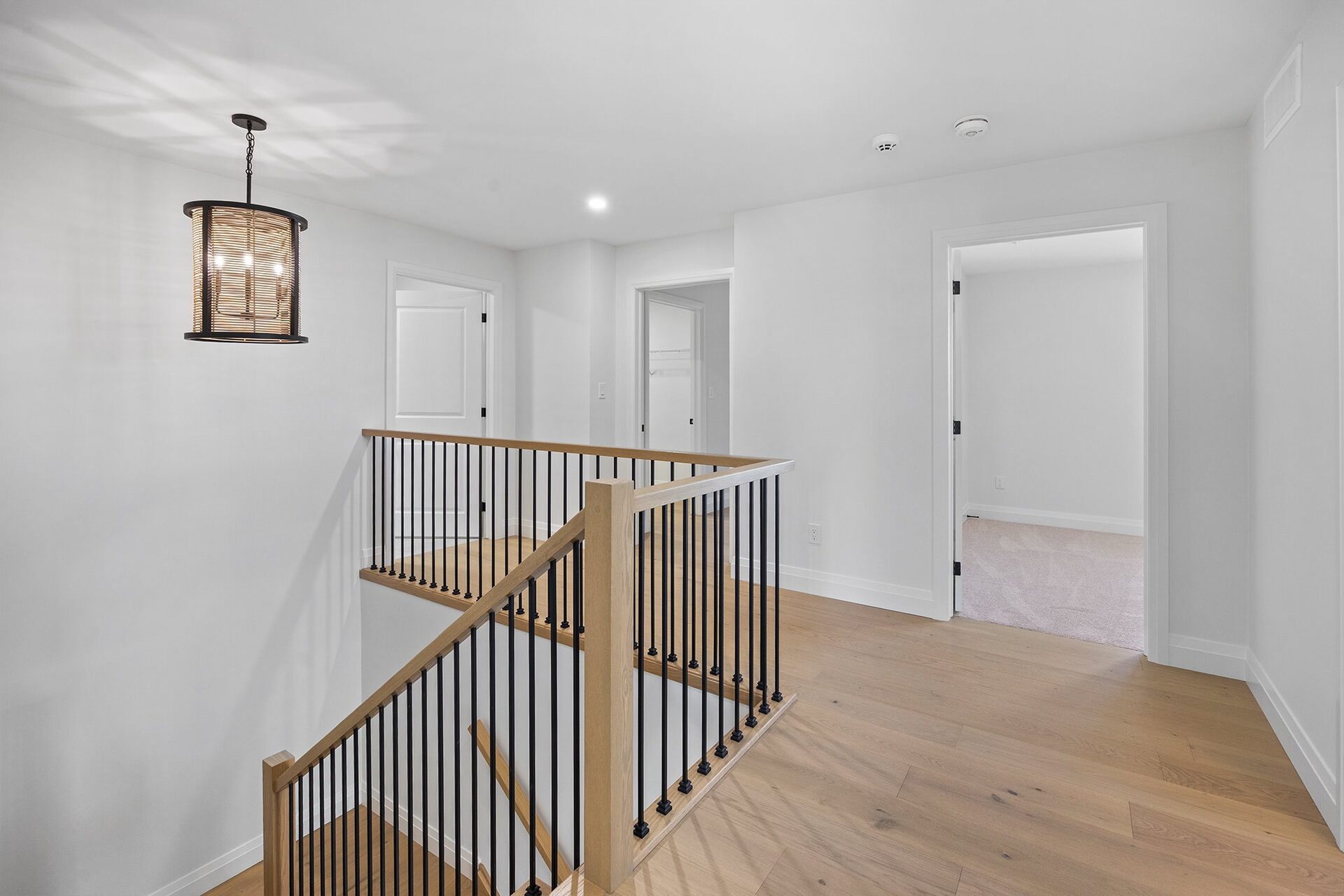 Upper landing with an oak staircase and black spindle railing